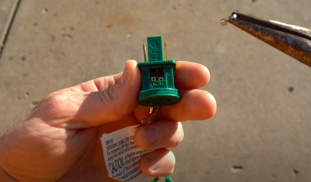 Man holding a fuse from christmas lights